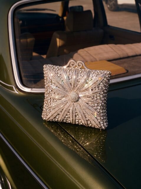 There’s a specific kind of magic that happens when vintage charm meets absolute brilliance. We took this shot and honestly, we just had to pause and stare for a second. ✨

Introducing ‘Tara’ a piece that doesn’t just carry your essentials; it carries the entire room’s attention. Inspired by the sharp, radiant glow of a North Star, this clutch is fully hand-embellished to catch the light from every single angle. Look at the way it reflects against the classic olive-green hood under the warm sun; it’s pure poetry. 🪐

This isn’t a piece you buy for one season. It’s the kind of heirloom bag you pass down, the one that makes you feel like an old-Hollywood starlet the moment your fingers touch it.

👑 Tara is now officially open for bookings. Drop us a DM or visit our website nenbyamber.com and bring this star into your wardrobe.